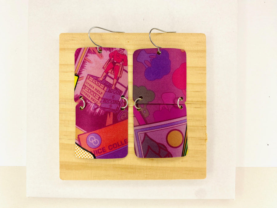 purple earrings made from upcycled craft beer can on a wooden and white background