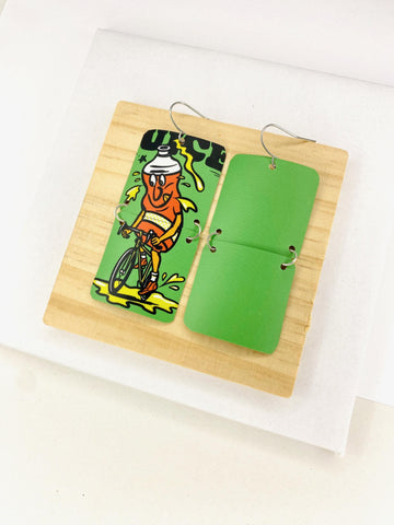 green earrings made from a craft beer can from Other Half Brewery on a wooden and white background