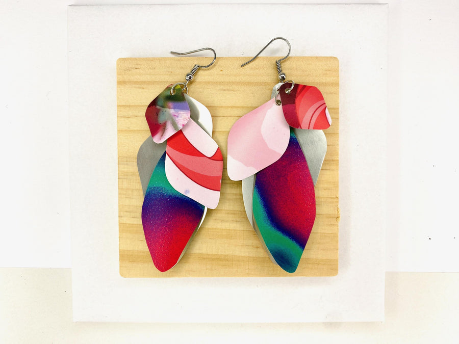 Pink purple green cascade earrings made from upcycled craft beer cans by Laura Zabo on a wooden and white background