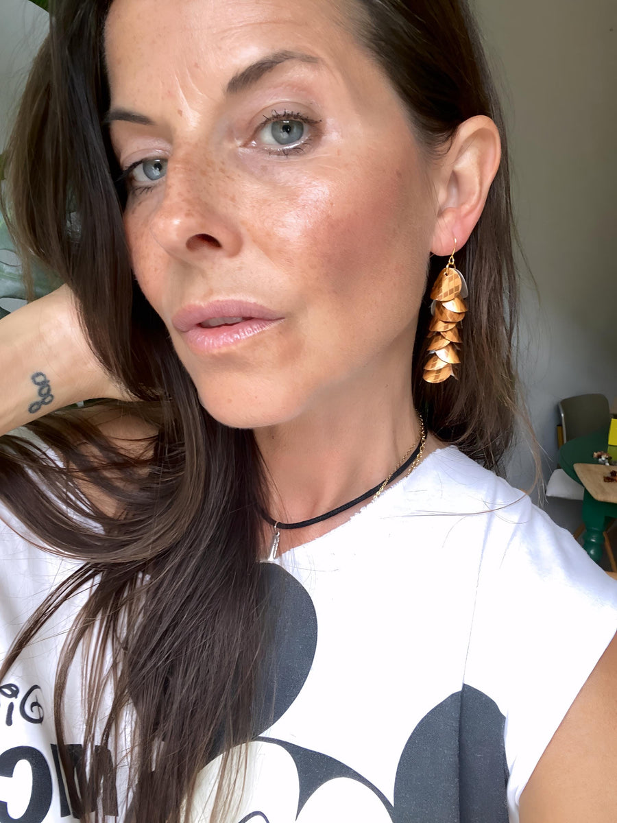 model wears rust-copper coloured cascade earrings made from Nespresso Cape Town Lungo Capsules by Laura Zabo