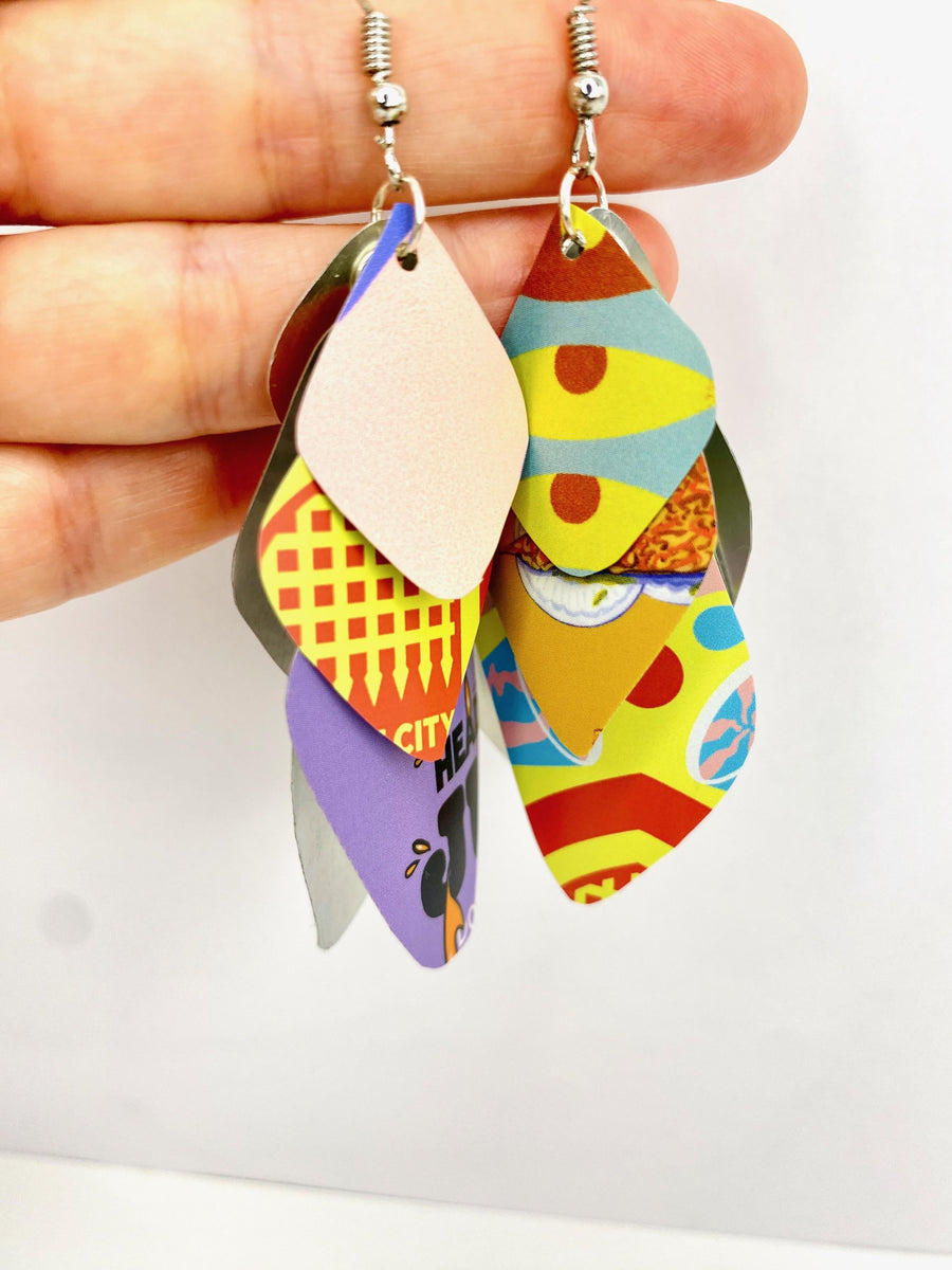 Laura Zabo, colourful , boho , bright cascade earrings made from upcycled craft beer cans on a wooden and white background