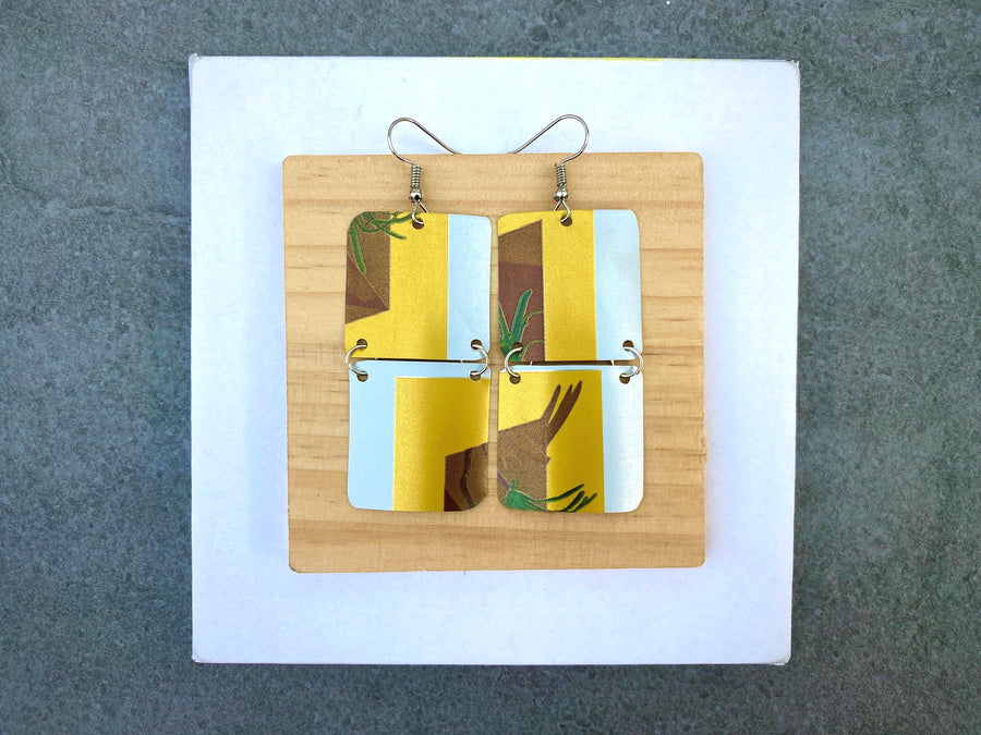yellow white brown green earrings made from shiny soda cans by laura zabo on a white a grey background