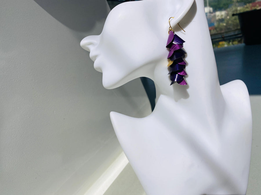 upcycled purple coloured cascade earrings made from repurposed nespresso capsules by Laura Zabo on a white mannequin