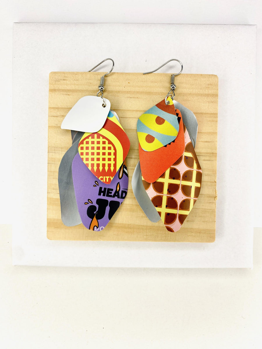 Laura Zabo, colourful , boho , bright cascade earrings made from upcycled craft beer cans on a wooden and white background