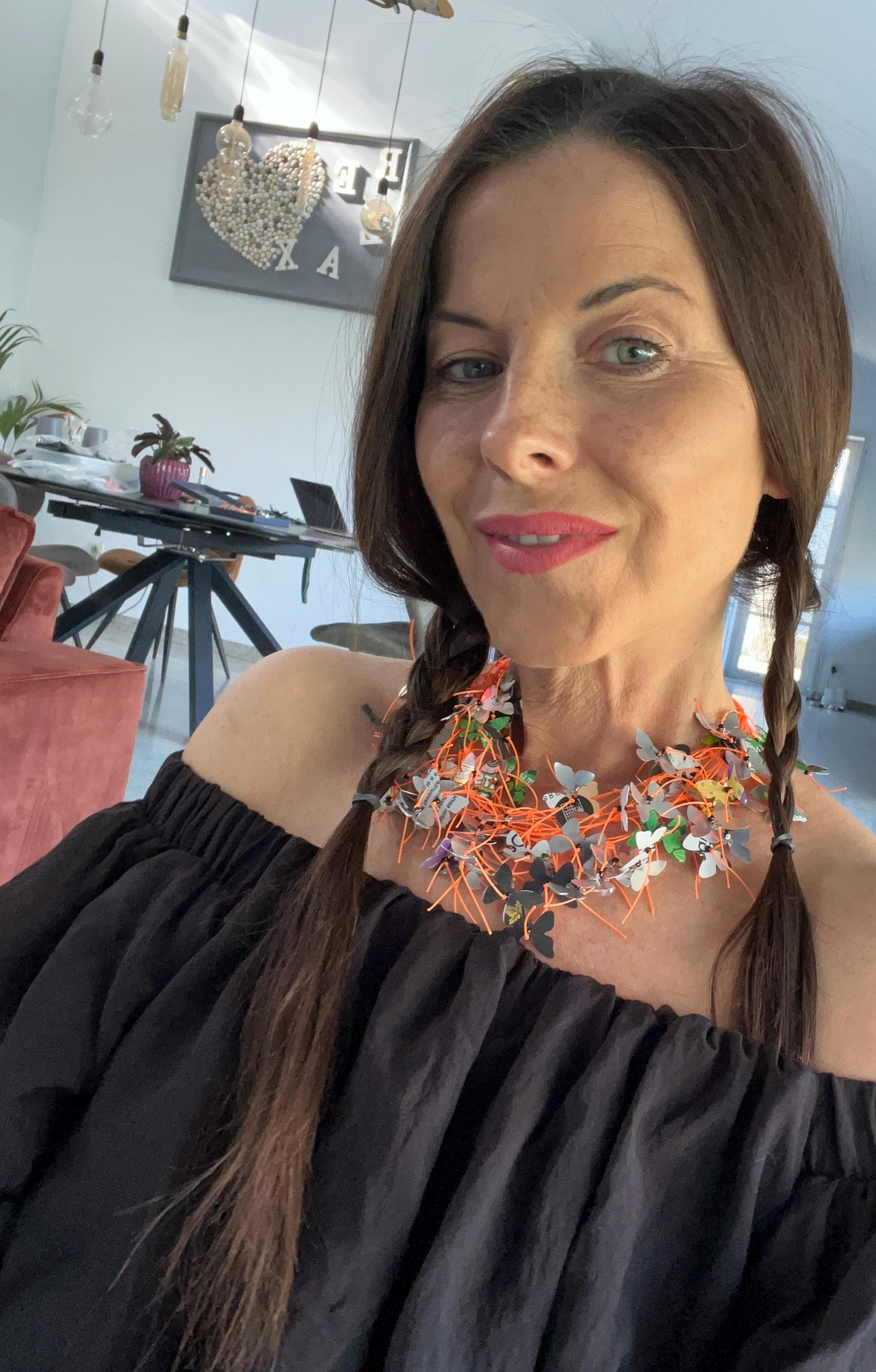orange cord and aluminium butterfly necklace, the butterflies are cut from upcycled soda and beer cans on a white mannequin