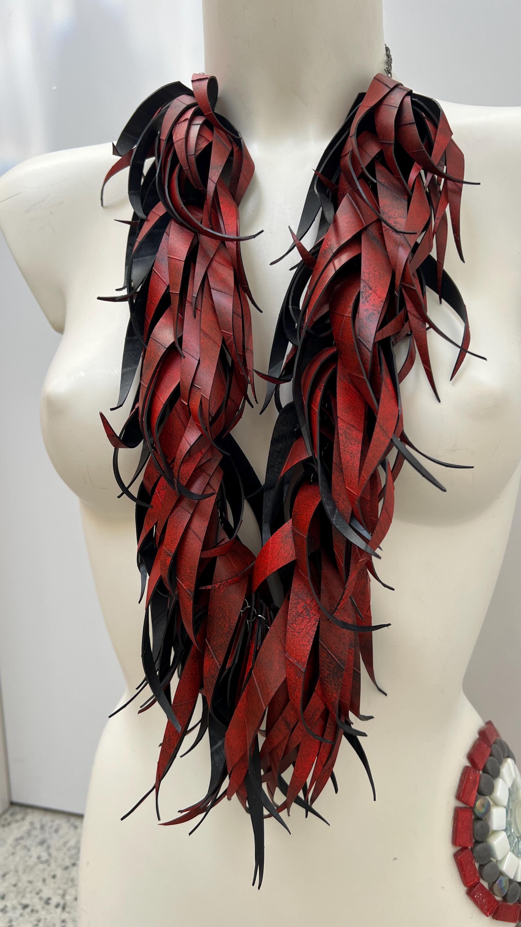 large, long red curly tassel neckace made from upcycled bicycle inner tube rubber on a white mannequin