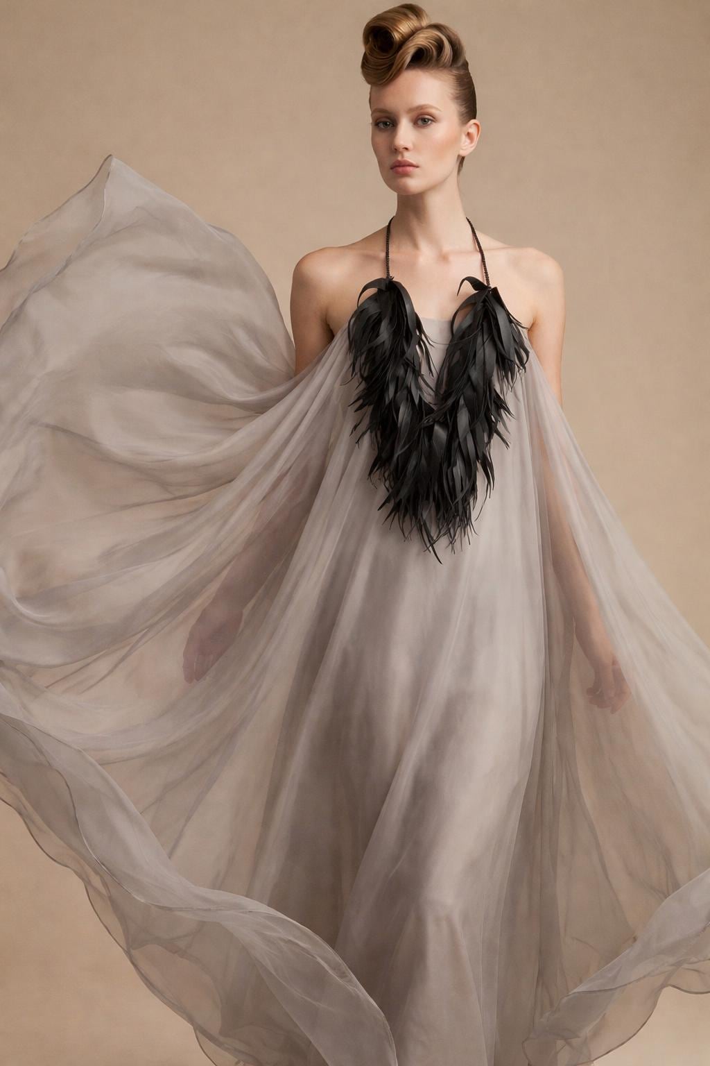 very large, oversized black curly tassel made from upcycled bicycle inner tube tassels on a white mannequin