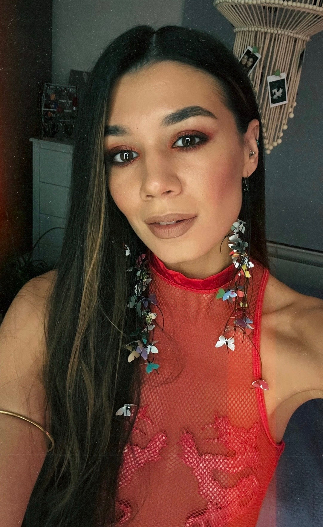 Woman wearing a red dress with laura zabo earrings made from craft beer cans featuring tiny butterflies 