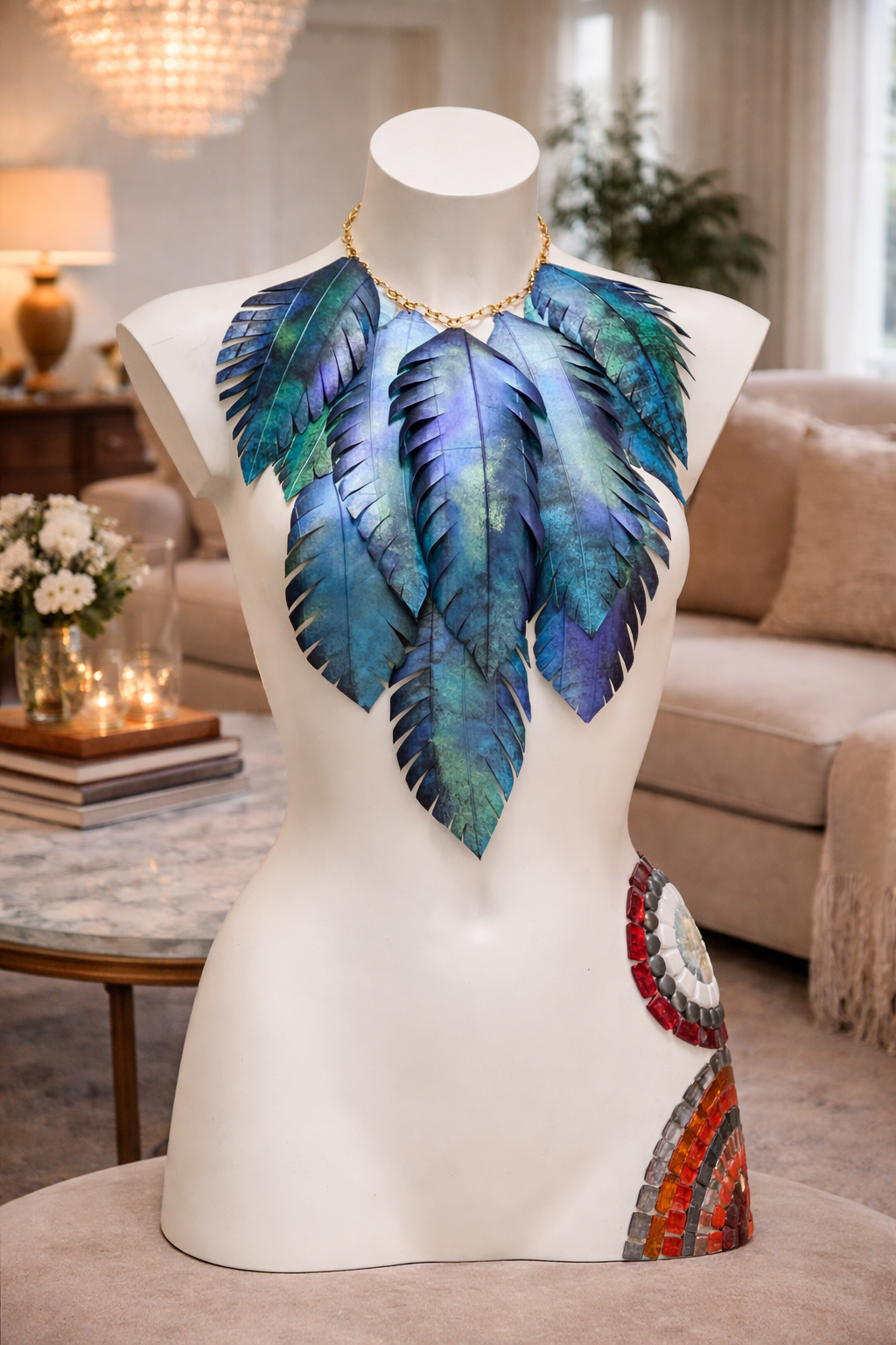 Mannequin wearing a blue-green leaf  shaped statement necklace made from upcycled bicycle inner tube in a home setting