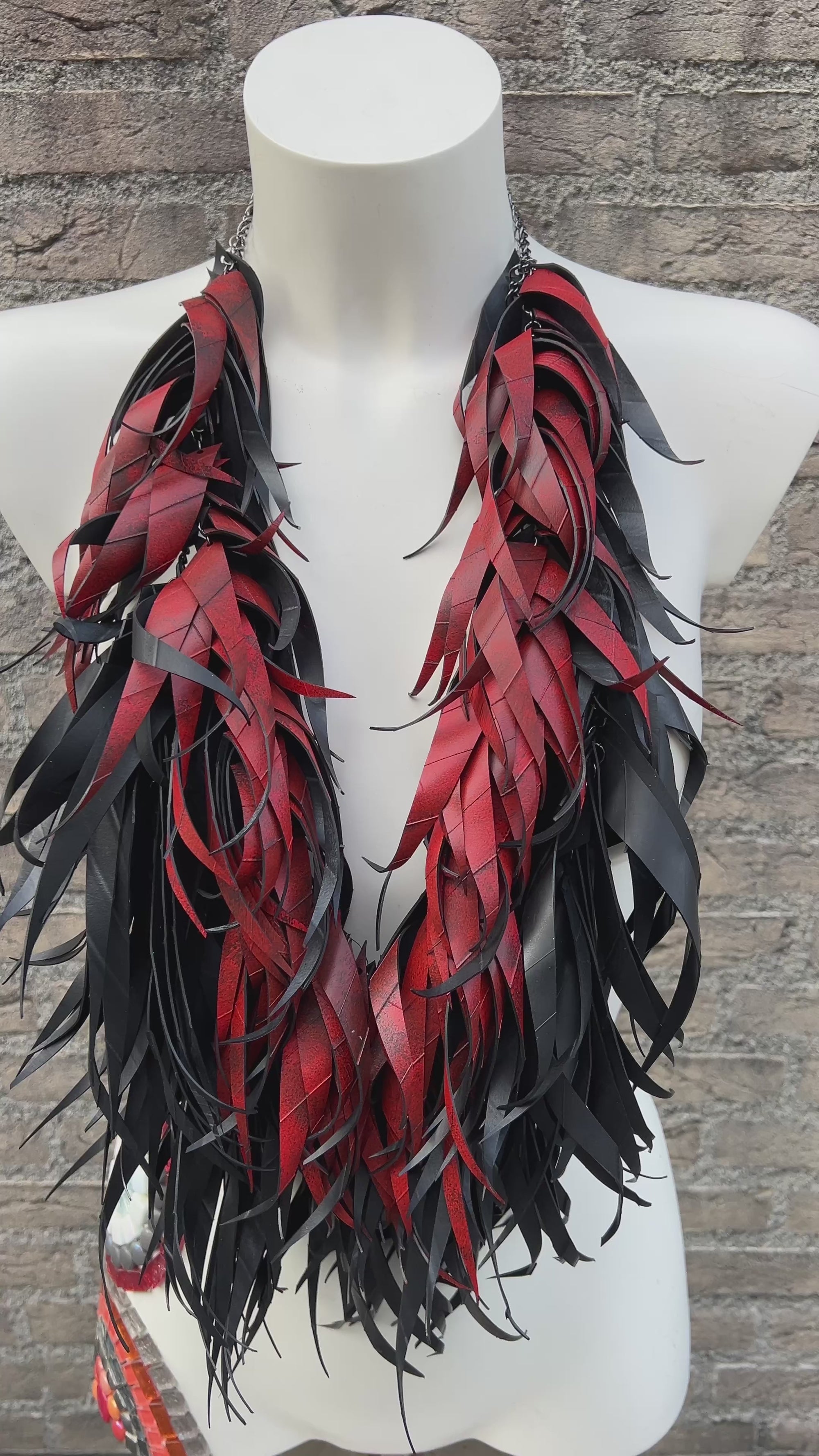 mannequin wear large, red black curly tassel necklace made from upcycled bicycle tyre rubber
