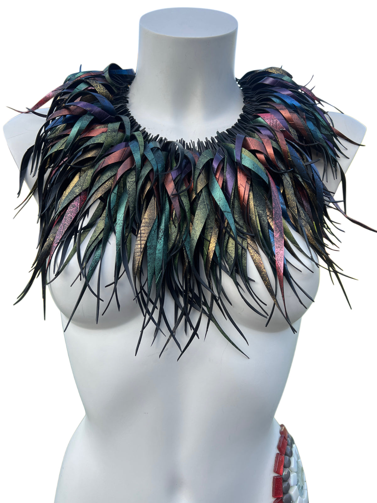 curly tassel, chunky necklace made from upcycled bicycle inner tube rubber, in metallic blue, green, red, bronze and gold colours, on a white mannequin against a white background