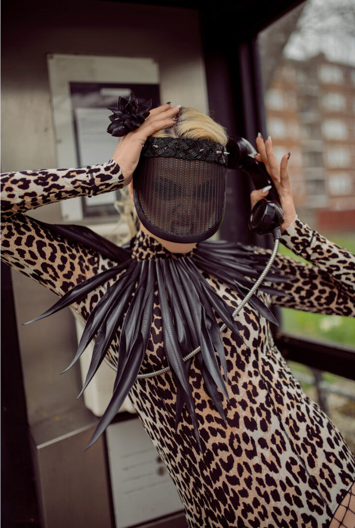 model wears a  large black leather looking  collar, statement neckpiece made from upcycled bicycle inner tube rubber 